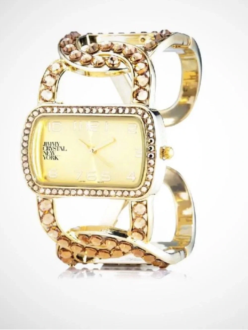 Jimmy Crystal elegant gold tone cuff watch with sparkling crystal accents.